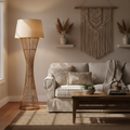 Bohemian woven rattan floor lamp with beige shade in a cozy living room